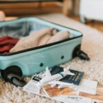 black and green luggage bag on brown carpet